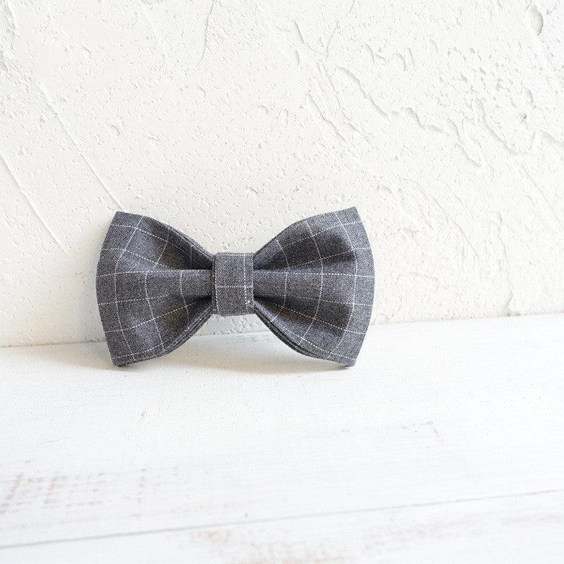 Dog wearing a stylish polyester bowtie accessory from Dog Hugs Cat, a luxury dog collar or harness for pets.