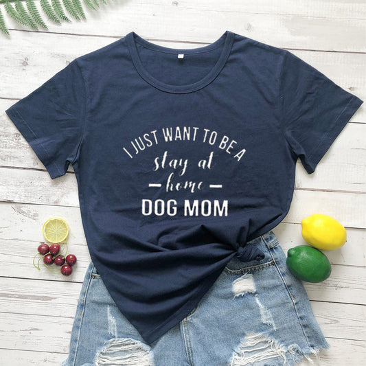 White T-shirt with black text saying "I Just Want To Be A Stay At Home Dog Mom" by PAWSOME PETS, casual and comfortable fit.