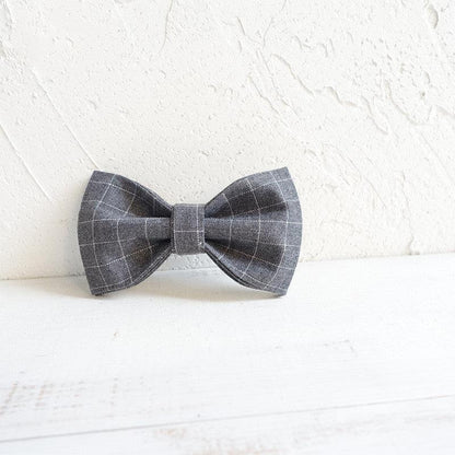 Dog wearing a stylish polyester bowtie accessory from Dog Hugs Cat, a luxury dog collar or harness for pets.