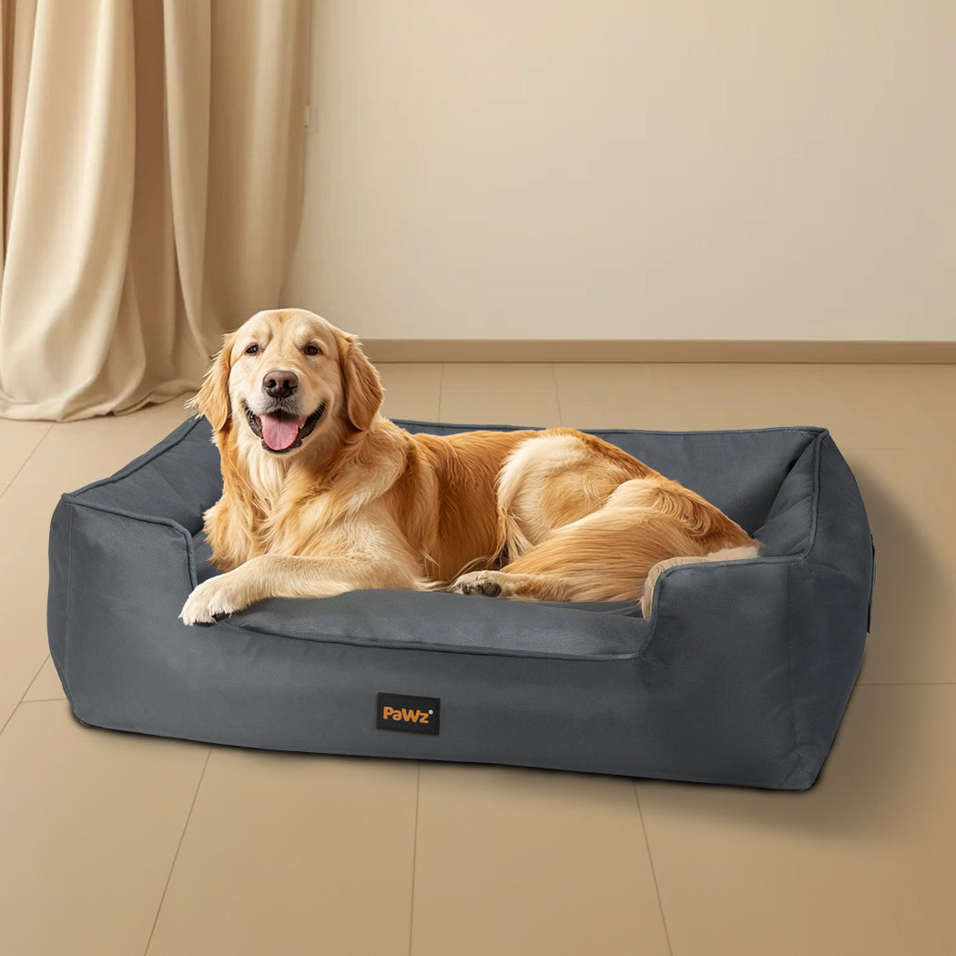 NNEIDS Pawz waterproof pet dog calming bed with soft fabric and cozy design, shown in a home living room setting.