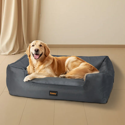 NNEIDS Pawz waterproof pet dog calming bed with soft fabric and cozy design, shown in a home living room setting.