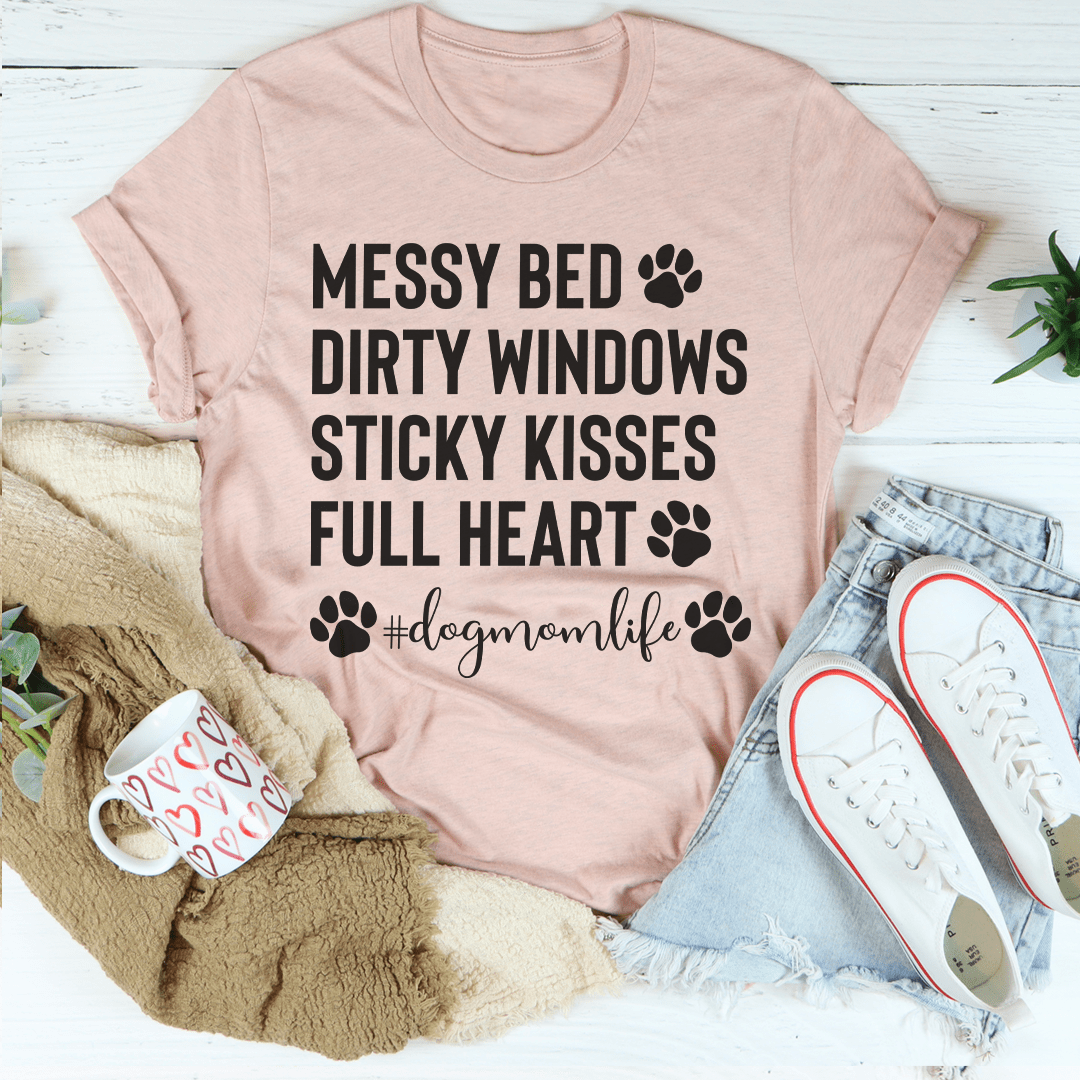 Peach-colored Dog Mom Life T-shirt by MerchMallow featuring playful dog-themed text on a casual cotton tee.