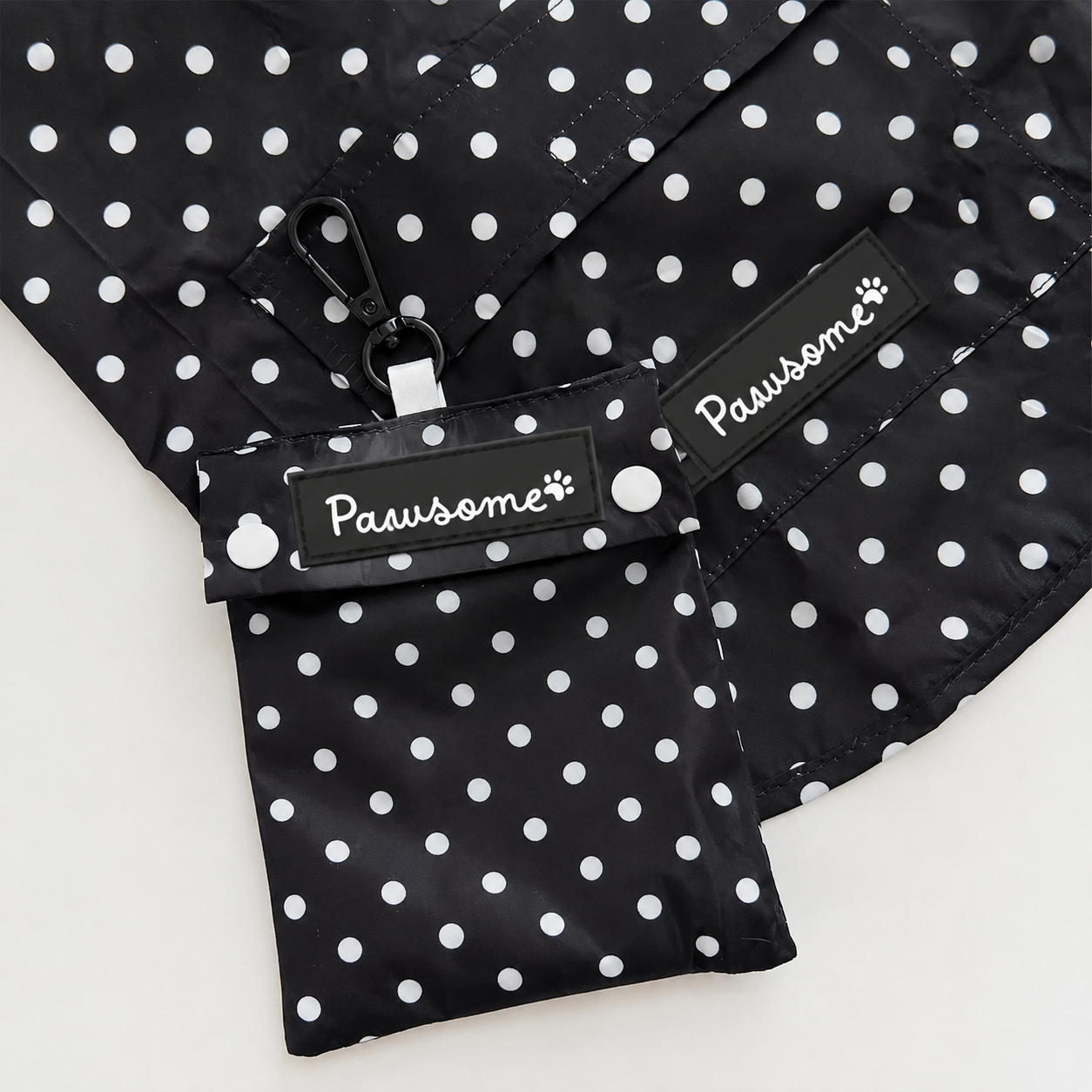 Polka dot waterproof dog raincoat with hood and pouch by Pawsome Pet Store, shown in a vibrant polka dot pattern.